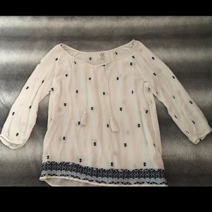 White top with blue designs